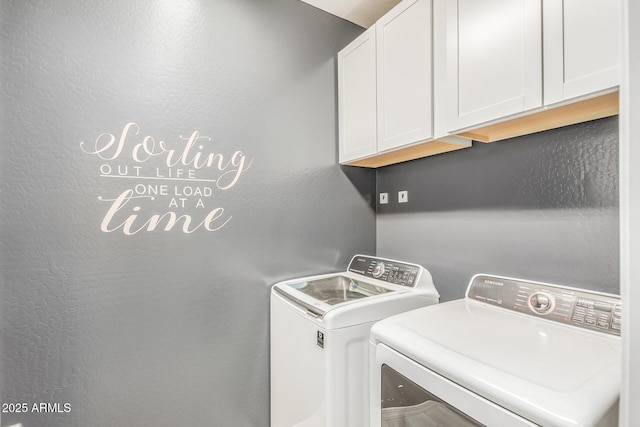 laundry room with cabinets and washing machine and dryer