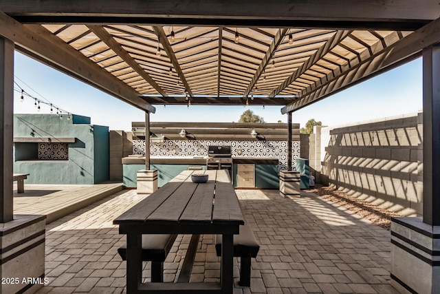 view of patio with a pool, a pergola, exterior kitchen, and a grill