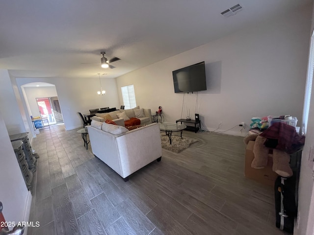 living room with ceiling fan, plenty of natural light, and dark hardwood / wood-style flooring