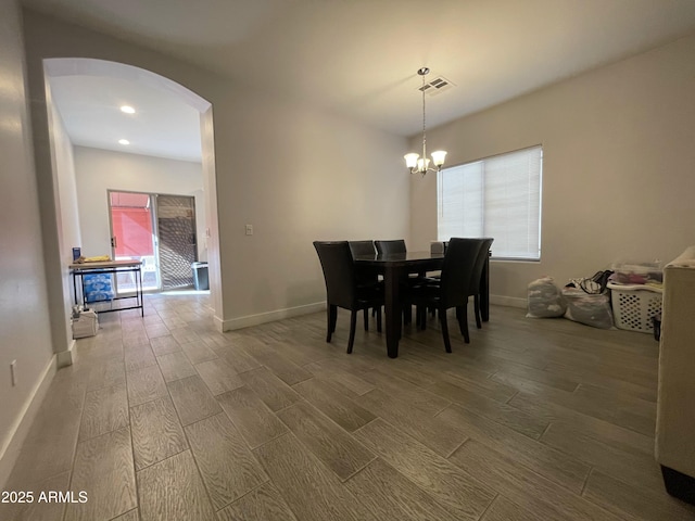 dining space featuring an inviting chandelier and wood-type flooring