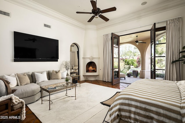 bedroom featuring ornamental molding, a fireplace, visible vents, and tile patterned floors