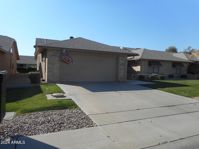 view of front of property with a front yard and a garage