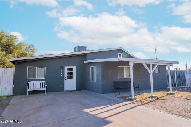 rear view of property featuring central AC and a patio area