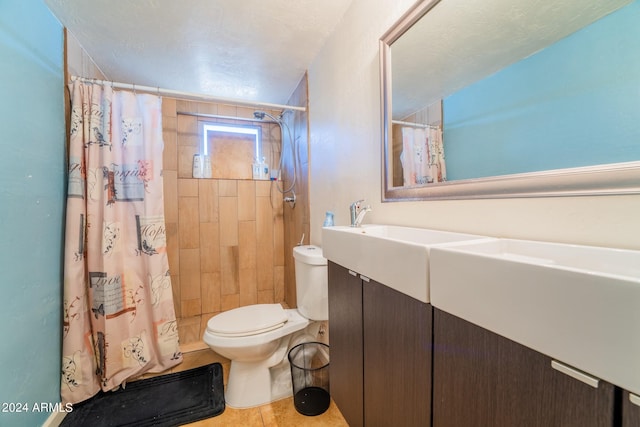 bathroom with curtained shower, tile patterned flooring, vanity, and toilet