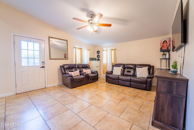 living room with ceiling fan, light tile patterned flooring, and vaulted ceiling