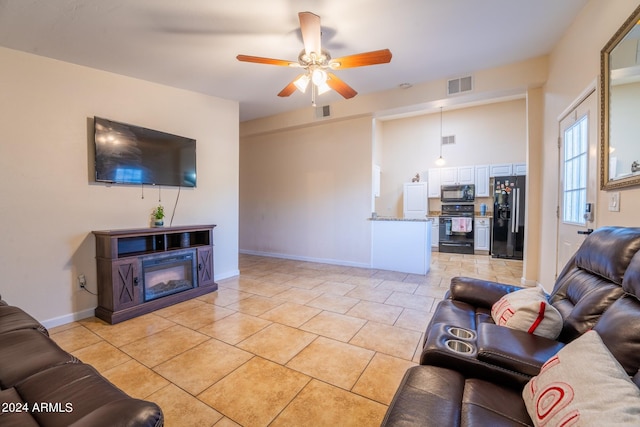 tiled living room featuring ceiling fan