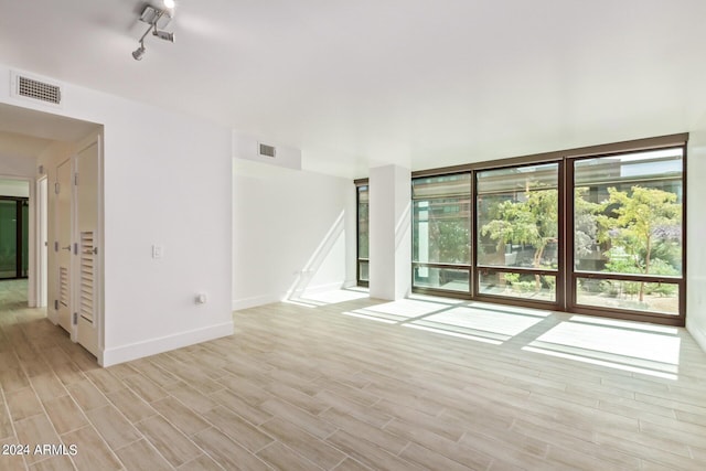 4808 N 24th St Unit 230, Phoenix, AZ 85016 - unfurnished room with light wood-style flooring and baseboards