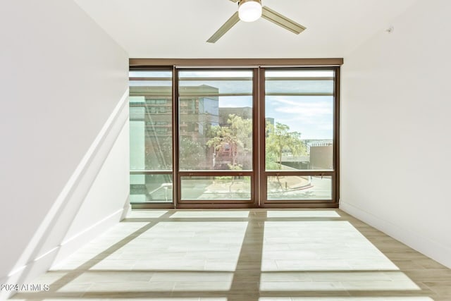4808 N 24th St Unit 230, Phoenix, AZ 85016 - entryway featuring ceiling fan, expansive windows, wood finished floors, and baseboards