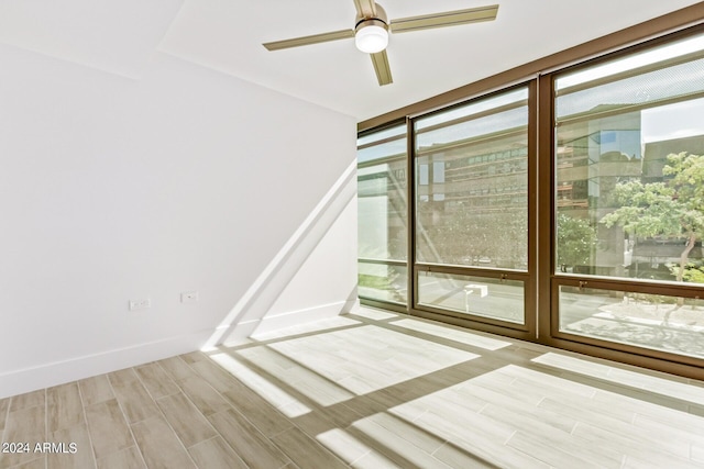 4808 N 24th St Unit 230, Phoenix, AZ 85016 - unfurnished room with plenty of natural light, wood finished floors, and a ceiling fan