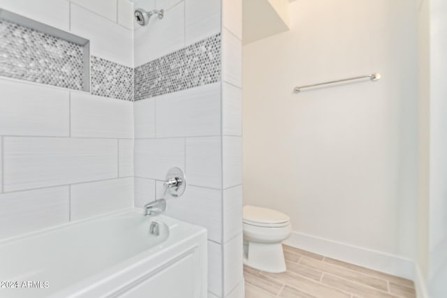 4808 N 24th St Unit 230, Phoenix, AZ 85016 - full bath with toilet, baseboards, shower / bath combination, and wood finish floors