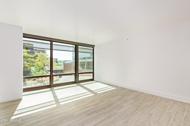 4808 N 24th St Unit 230, Phoenix, AZ 85016 - unfurnished room with light wood-style flooring and expansive windows