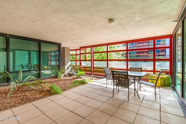 4808 N 24th St Unit 230, Phoenix, AZ 85016 - sunroom featuring tile patterned flooring, a textured ceiling, and floor to ceiling windows
