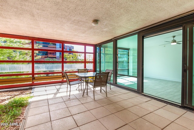 4808 N 24th St Unit 230, Phoenix, AZ 85016 - sunroom featuring a textured ceiling, tile patterned floors, outdoor dining area, expansive windows, and a ceiling fan