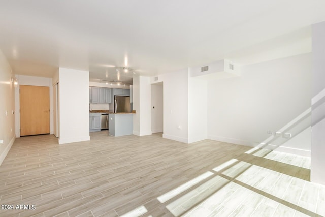 4808 N 24th St Unit 230, Phoenix, AZ 85016 - unfurnished living room featuring baseboards and light wood-type flooring