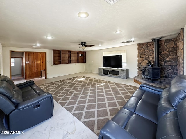 9107 W Fossil Creek Rd, Strawberry, AZ 85544 - living area featuring a ceiling fan, a wood stove, and recessed lighting