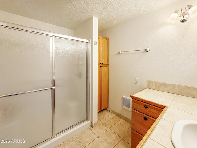 9107 W Fossil Creek Rd, Strawberry, AZ 85544 - bathroom featuring a stall shower, tile patterned floors, a textured ceiling, and vanity