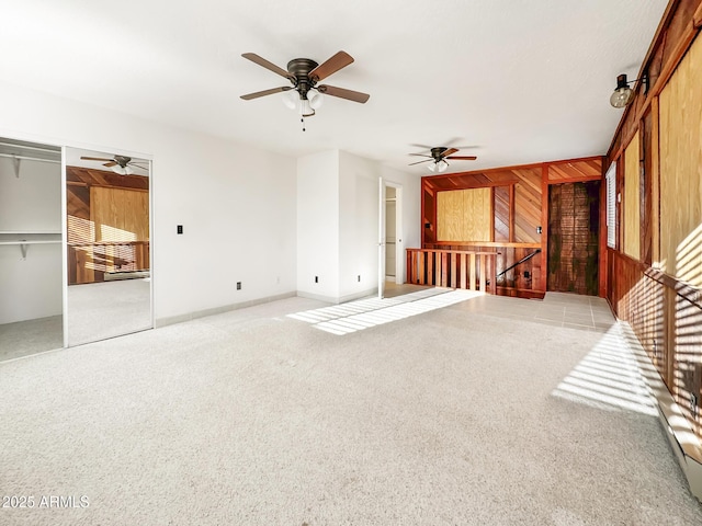 9107 W Fossil Creek Rd, Strawberry, AZ 85544 - unfurnished living room featuring a ceiling fan, carpet, and wood walls