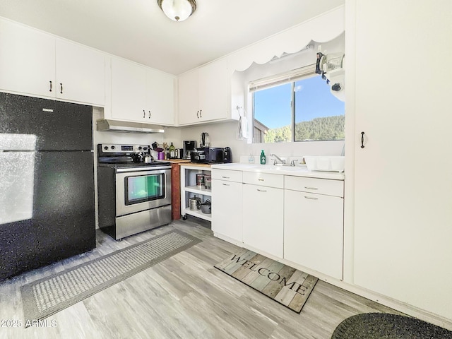 9107 W Fossil Creek Rd, Strawberry, AZ 85544 - kitchen featuring freestanding refrigerator, stainless steel electric range, light wood-style flooring, light countertops, and under cabinet range hood