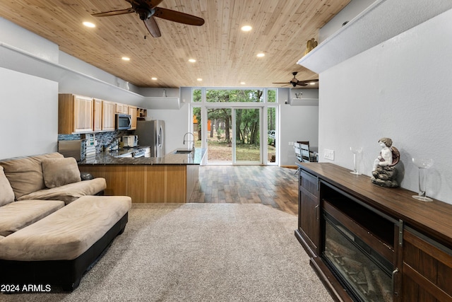 kitchen featuring wood ceiling, appliances with stainless steel finishes, kitchen peninsula, and sink