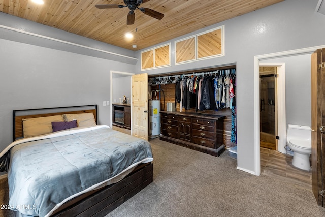 bedroom with wood ceiling, electric water heater, a closet, ceiling fan, and carpet