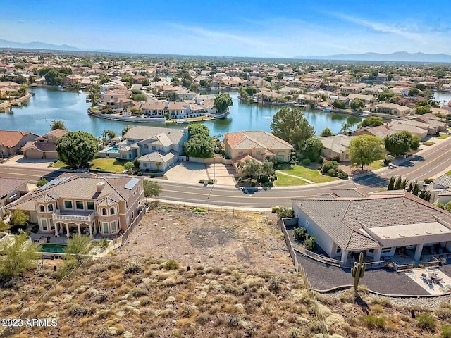 drone / aerial view featuring a water and mountain view