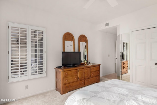 bedroom featuring a ceiling fan, light colored carpet, visible vents, and baseboards