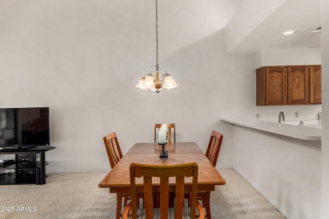 dining area with a chandelier, light carpet, and baseboards