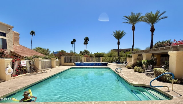 pool featuring a patio and fence