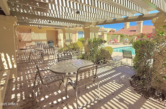 view of patio / terrace featuring fence, a community pool, and a pergola