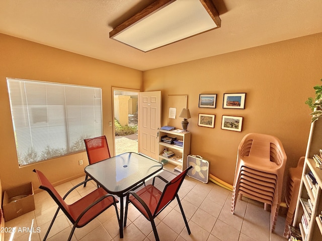 dining room with baseboards and light tile patterned flooring