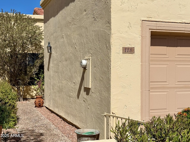 view of home's exterior with a garage and stucco siding