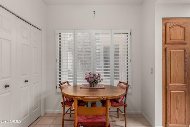 dining room featuring light tile patterned floors and baseboards