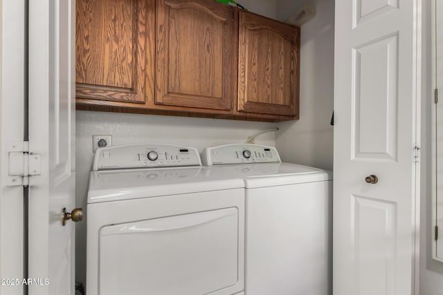 laundry area featuring cabinet space and separate washer and dryer