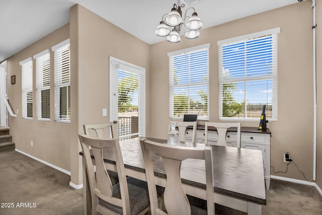 7718 W Pipestone Pl, Phoenix, AZ 85035 - carpeted dining space with baseboards, a chandelier, and stairs