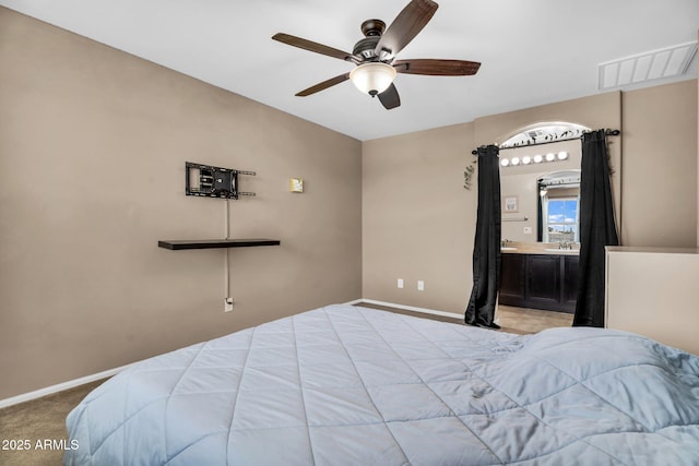 7718 W Pipestone Pl, Phoenix, AZ 85035 - bedroom with baseboards, carpet flooring, ensuite bath, and a ceiling fan