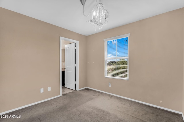 7718 W Pipestone Pl, Phoenix, AZ 85035 - spare room with carpet flooring, baseboards, and a chandelier