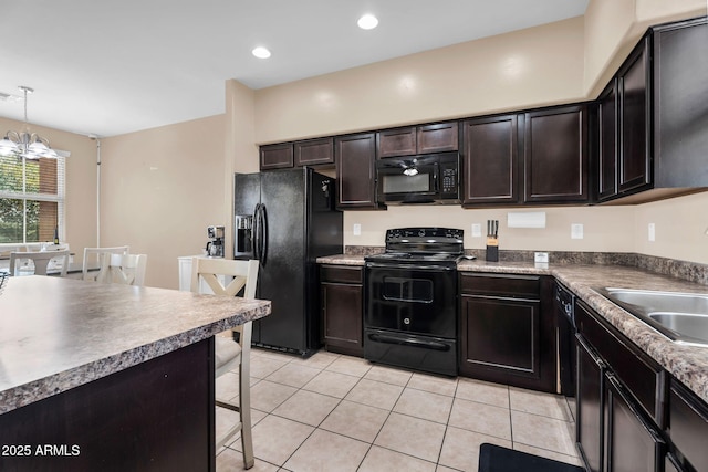 7718 W Pipestone Pl, Phoenix, AZ 85035 - kitchen with black appliances, a breakfast bar area, light tile patterned flooring, a chandelier, and a sink