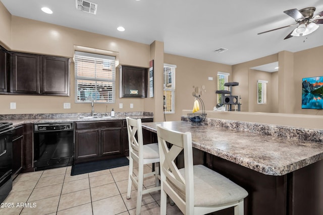 7718 W Pipestone Pl, Phoenix, AZ 85035 - kitchen featuring black appliances, a sink, light tile patterned flooring, dark brown cabinets, and a ceiling fan