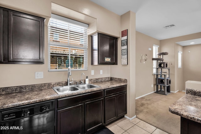 7718 W Pipestone Pl, Phoenix, AZ 85035 - kitchen with dishwasher, a sink, light carpet, light tile patterned flooring, and baseboards