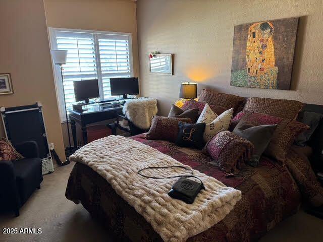 bedroom featuring light carpet