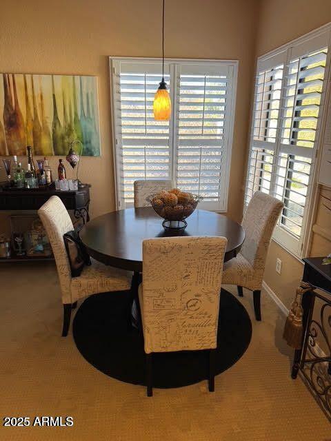 dining space featuring light colored carpet