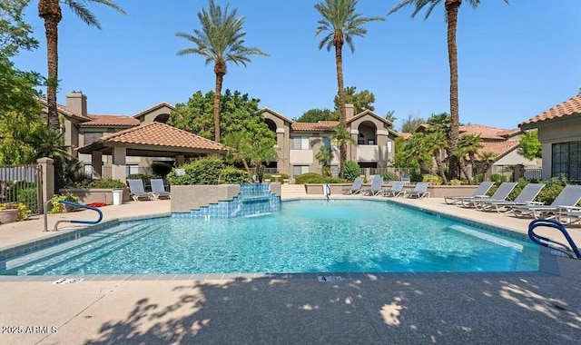 community pool with a gazebo, fence, and a patio