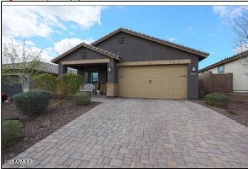 view of front facade with an attached garage and decorative driveway