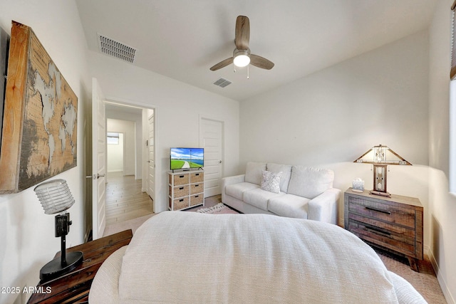 bedroom with visible vents, baseboards, and a ceiling fan