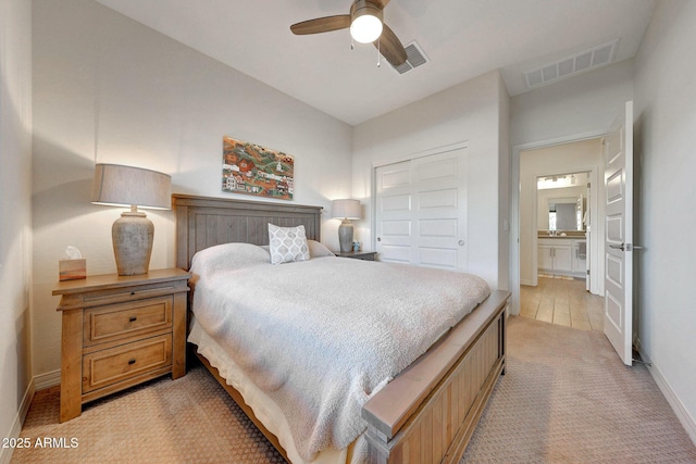 bedroom featuring baseboards, visible vents, a closet, and light carpet