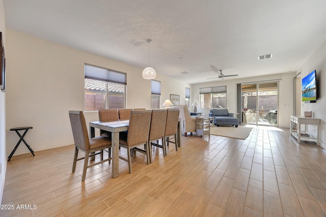 dining area with a ceiling fan, plenty of natural light, visible vents, and light wood-type flooring