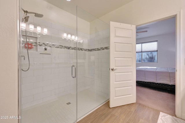 ensuite bathroom with a shower stall, ensuite bathroom, and wood finish floors
