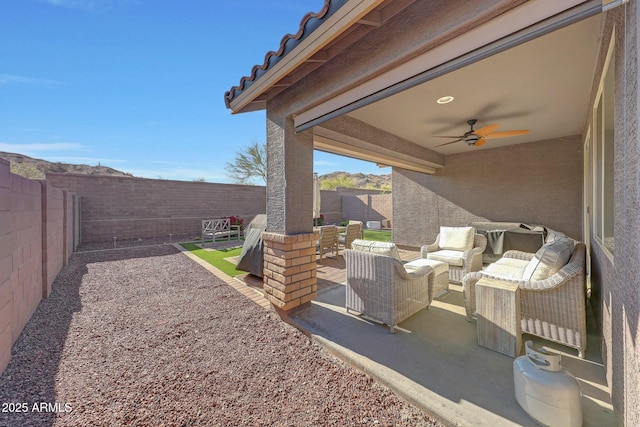 view of patio / terrace with ceiling fan, an outdoor hangout area, and a fenced backyard