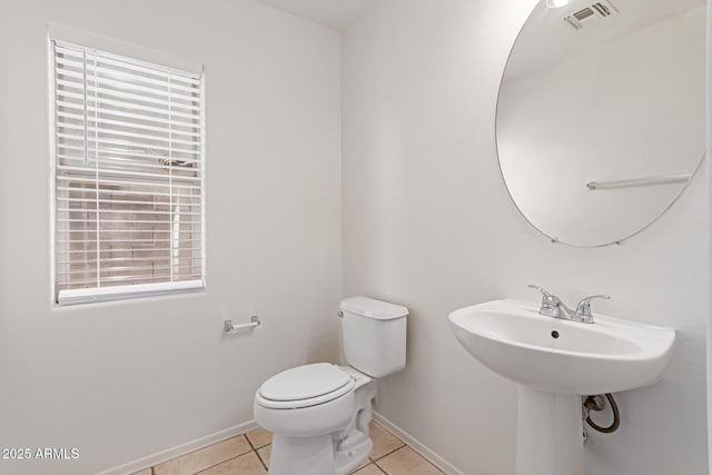 bathroom with tile patterned flooring and toilet