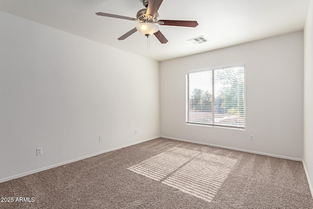 empty room with ceiling fan and carpet